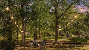 A park with trees, a fire pit, and chairs. - Cozy Home w/ Pool Table, Arcade & Firepit (Spartanburg)