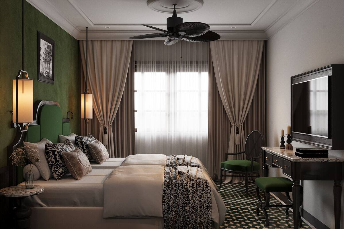 A hotel room with a bed, a desk, a television, and a ceiling fan.