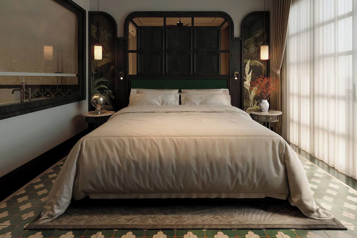 A spacious bedroom with a large bed, a ceiling fan, and a view of the outdoors through a window with sheer curtains.