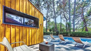 A wooden deck with lounge chairs and a pool. - Villa les Verdiers by Interhome (Biscarrosse)