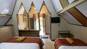 A room with two beds, a mirror, a television, and a view of the outside. - Coralview Resort BlueStar - Perhentian (Pulau Perhentian Besar)