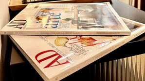 A magazine on a table with a lamp and a vase of flowers. - WAKAFLATS 1, CHUECA SB (Madrid)