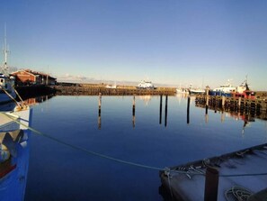 A calm harbor with boats docked, wooden piers, and a clear sky. - 4 Person Holiday Home in Thyboron (Thyborøn)
