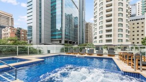 A rooftop pool with a jacuzzi, surrounded by modern buildings. - Top Floor! 2Bed/2Bath/1Car/Pool/Views ~ CBD (Brisbane City)