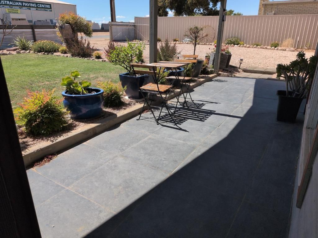 A patio area with a seating arrangement and potted plants.