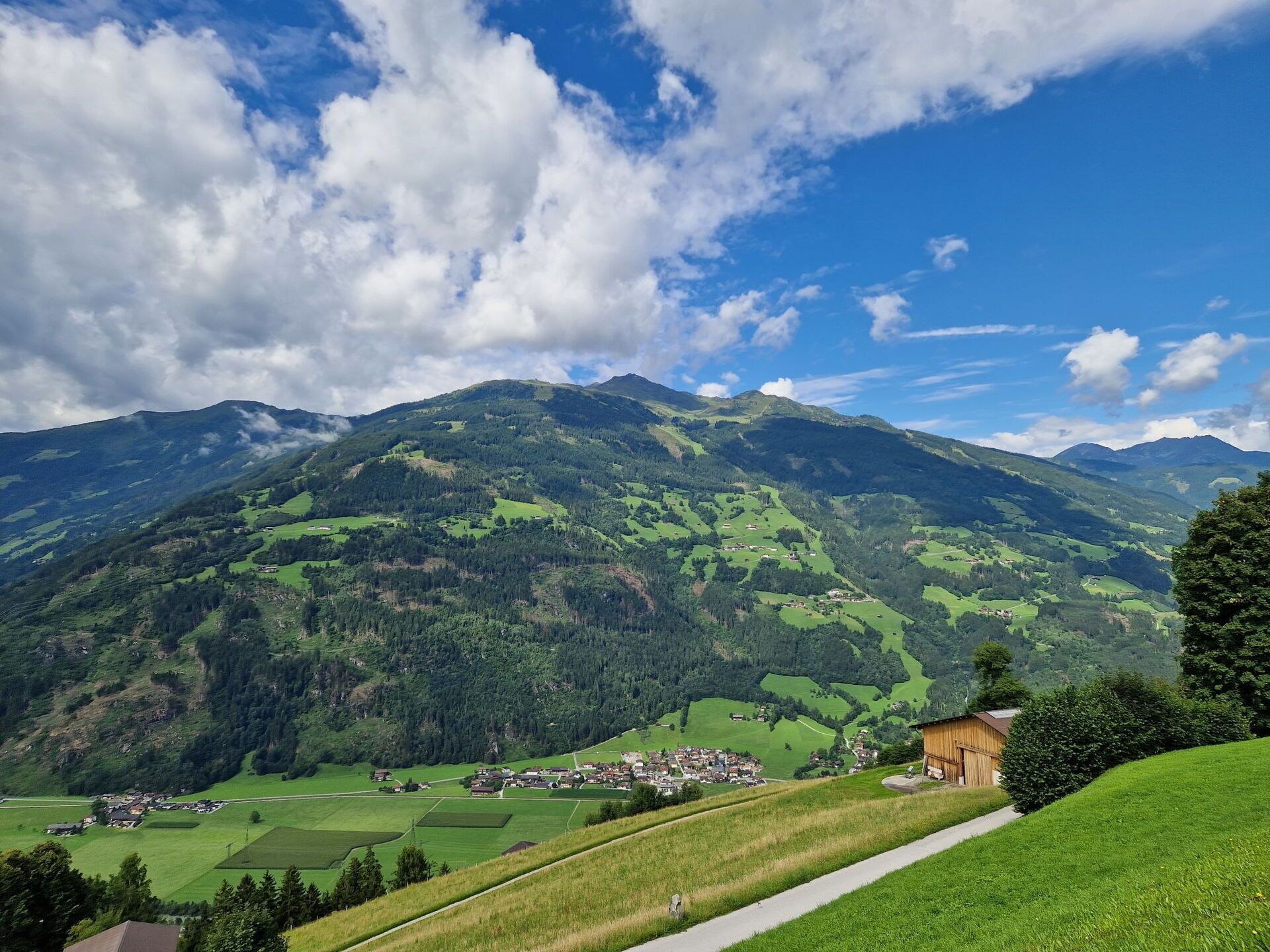 A mountainous landscape with a village nestled in the valley.