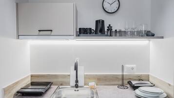 A modern kitchen with a built-in stove, a sink, and a countertop.