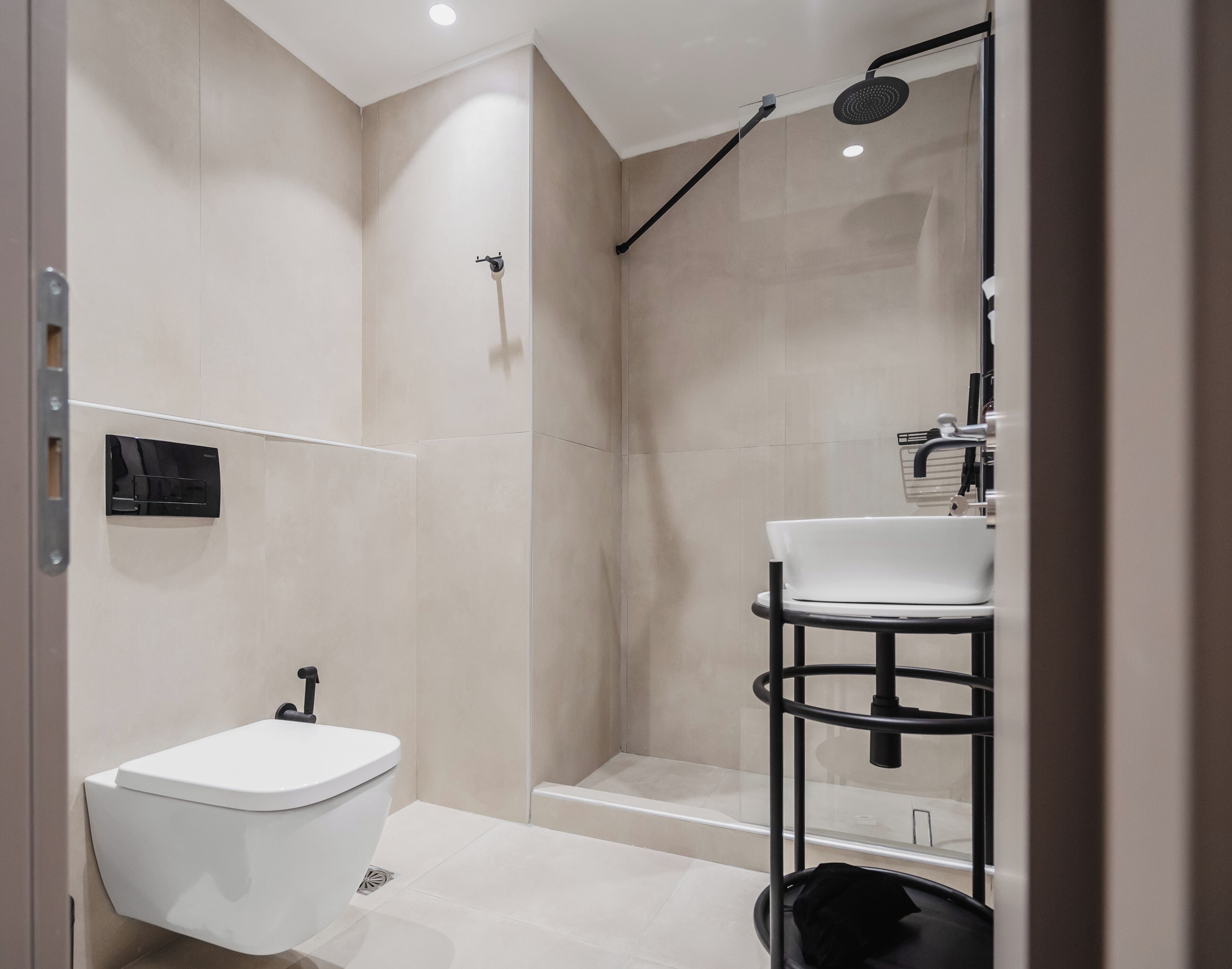 A modern bathroom with a toilet, sink, and shower.