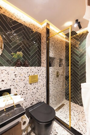 Shower, hair dryer, towels, toilet paper