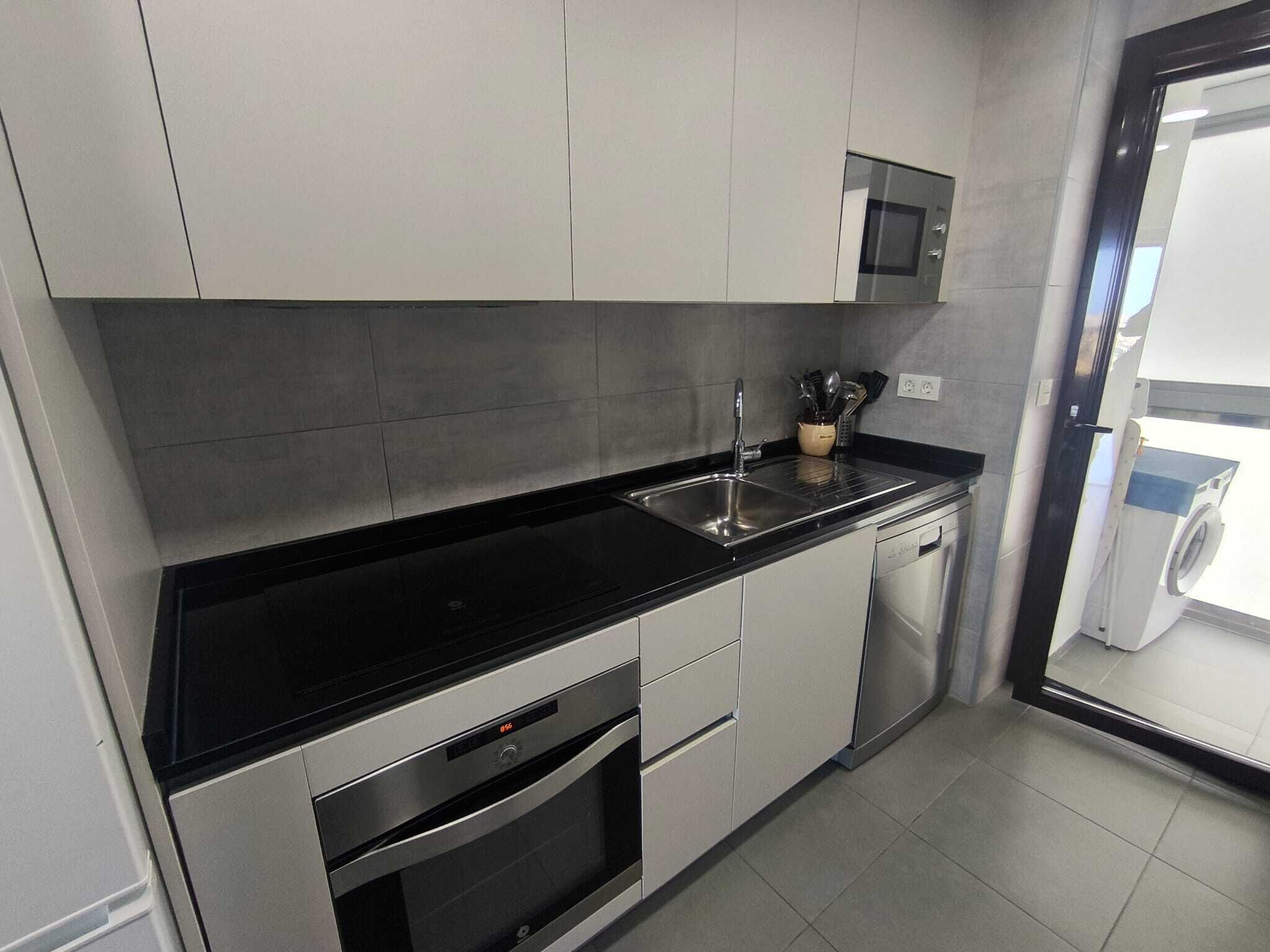 Een magnetron, een oven, een kookplaat, een vaatwasser