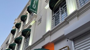 A building with a green awning and a sign that reads "HELLO".
