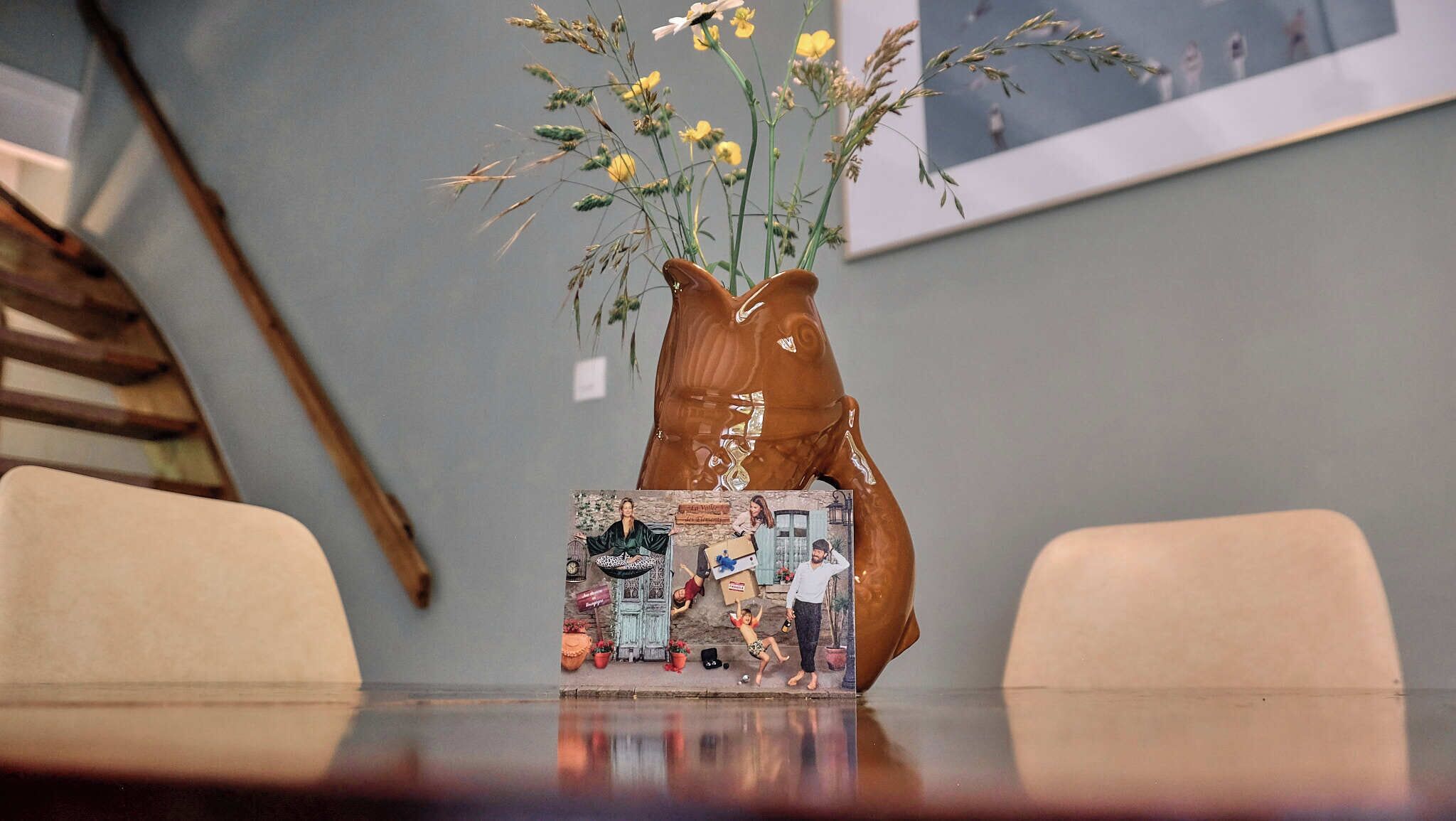 A table with a vase of flowers and a decorative box.