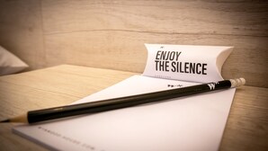 A wooden table with a white notepad and a pencil. - Magnificent 3BR in the Heart of Barranco (Lima)