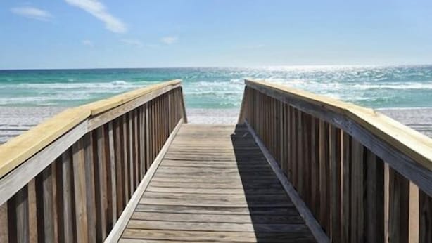 A wooden boardwalk leading to a beach with waves crashing onto the shore. - Emerald Towers West #4002 - Beachfront - 2 King Suites - Free Beach Service! (Fort Walton Beach)