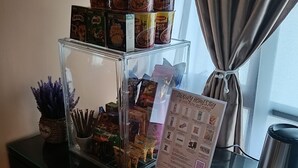 A glass display case with snacks and a menu on a hotel reception desk.