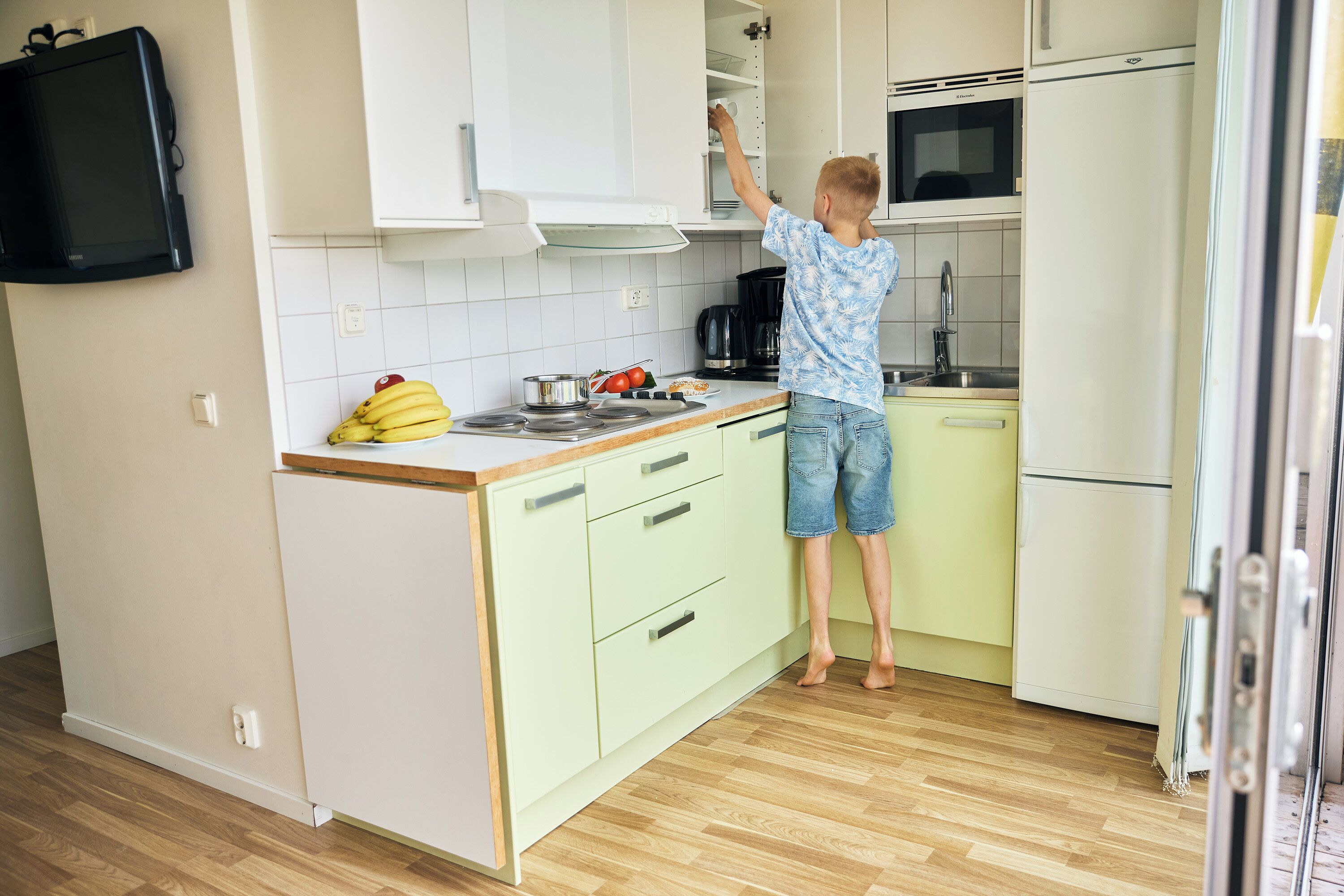 A kitchen with a microwave, stove, and cabinets.