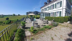 Un hôtel doté d’une terrasse, d’un espace couvert et offrant une vue sur le paysage environnant.