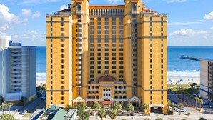 A large hotel with multiple floors, a central courtyard, and a view of the ocean. - Anderson Ocean Club #1611 (Myrtle Beach)