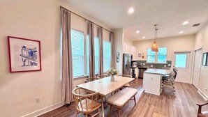 A modern kitchen with a dining area. - The Citrus Suite | Upscale Near UF/Downtown (Gainesville)