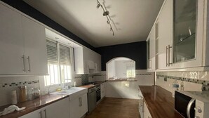 A modern kitchen with white cabinets, a wooden countertop, and a microwave. - Beautiful, fully equipped detached villa with a private swimming pool. (Zurgena)