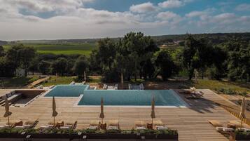 Outdoor pool, open 10:00 AM to 10:00 PM, pool umbrellas