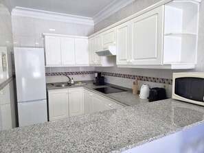 Fridge, microwave, stovetop, coffee/tea maker