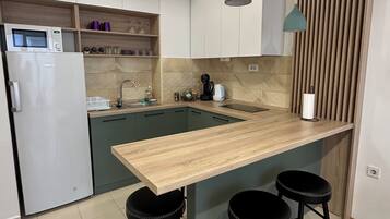 Fridge, microwave, stovetop, coffee/tea maker