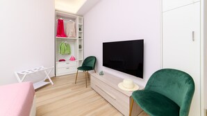 A modern bedroom with a bed, a TV, a wardrobe, and a desk. - Domus Sirenum - Teles (Sorrento)
