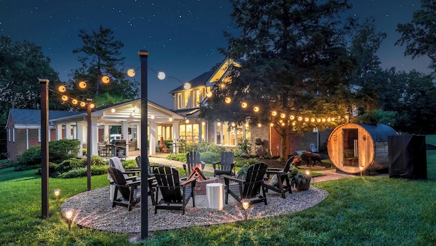 A house with a patio area featuring outdoor seating and a fire pit. - Bourbon Trail Estate, Golf Sim, SpeakEZ, Sleeps 14 (Frankfort)