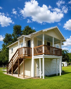 A two-story house with a covered porch, a staircase, and a garage.