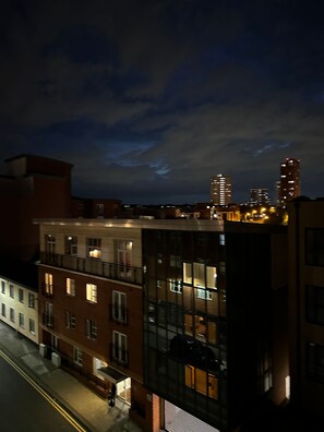 A multi-story building with a glass facade, a visible ground floor entrance, and a street in the foreground. - One Bedoom Flat in Birmingham City Centre With Free Underground Parking (Birmingham)
