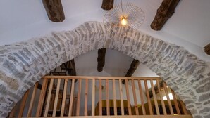 A stone archway with wooden beams and a wooden railing.