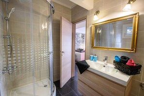 Shower, hair dryer, towels, toilet paper