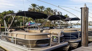 A dock with several pontoon boats, some with canopies, and a wooden walkway. - 2bed/2bath Club Wyndham Santa Barbara resort. Across St frm Pompano Beach w/pool (Pompano Beach)