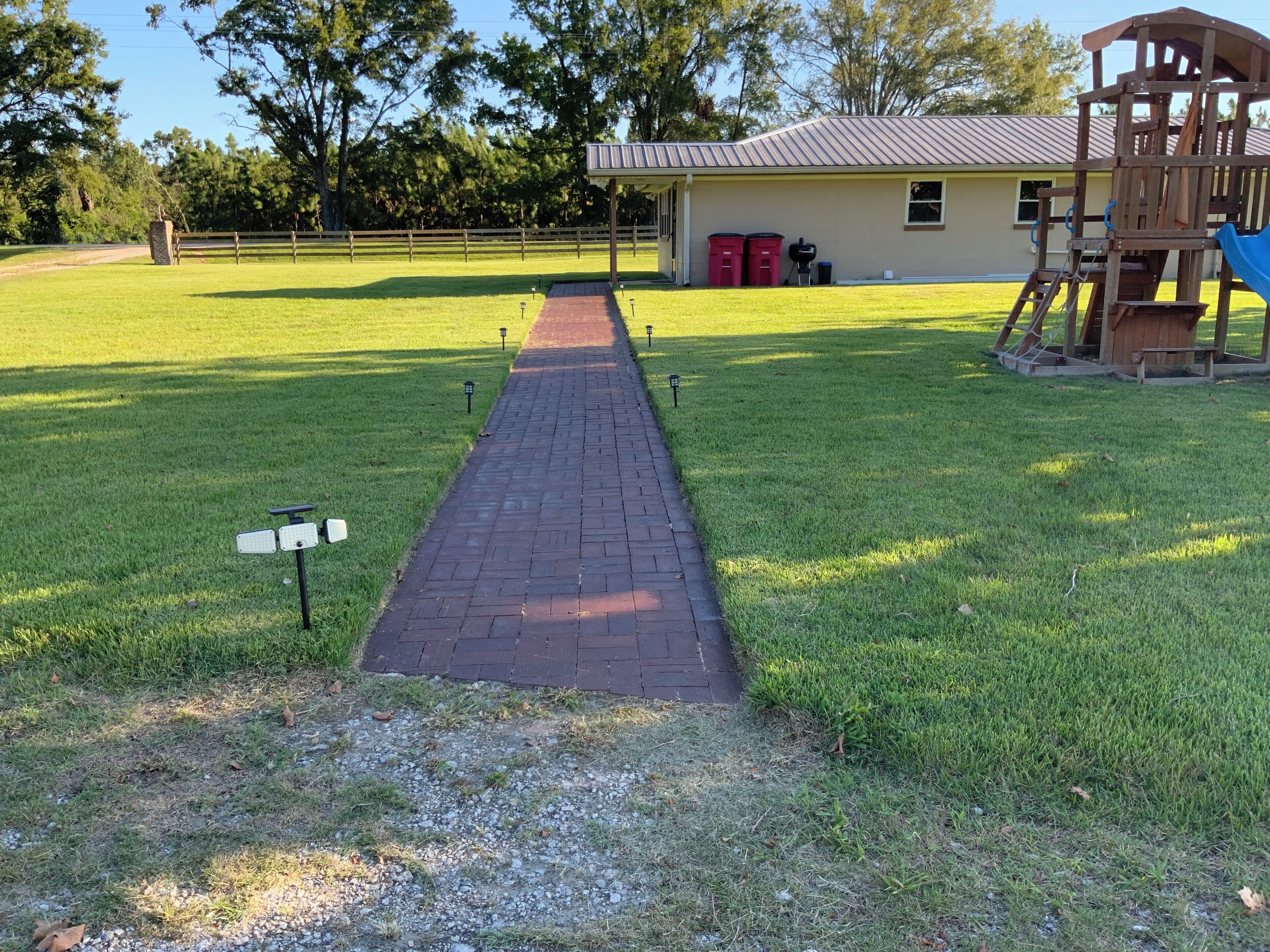A pathway leading to a building with a playground.