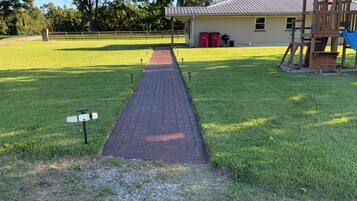 A pathway leading to a building with a playground.