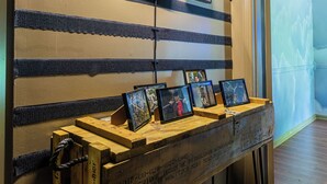 A wall with striped patterns and framed pictures. - Fort Winburn Military Home (Columbus)