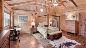 A wooden cabin bedroom with a four-poster bed, a desk, and a chair. - Cozy Mountain Cabin w/ Creek, near Dining & Hiking (Monteagle)