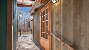 A wooden exterior with a glass door and a wooden deck. - Cozy Mountain Cabin w/ Creek, near Dining & Hiking (Monteagle)