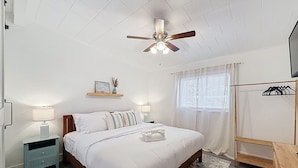 A bedroom with a bed, nightstands, a ceiling fan, a window with curtains, and a wooden dresser. - 3BR Largo Retreat w/ Private Pool & Patio (Largo)