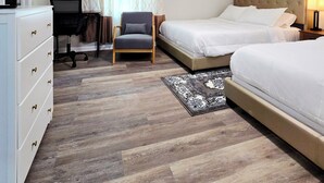 A hotel room with two beds, a desk, a chair, a ceiling fan, and a rug. - Spacious & beautiful 4-bedroom in a peaceful Severn, close to DC & Baltimore (Severn)