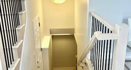 Entire basement with large windows, private full bathroom and office
