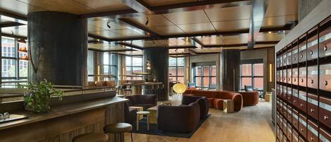 A modern interior with a bar area, seating, and storage lockers.