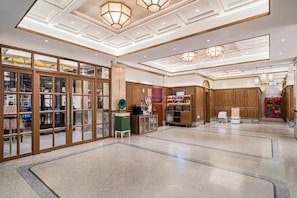 A spacious lobby with a high ceiling, wooden paneling, and a central reception desk. - Nostalgia S Hotel (Beijing Qianmen Tianqiao) (Beijing)
