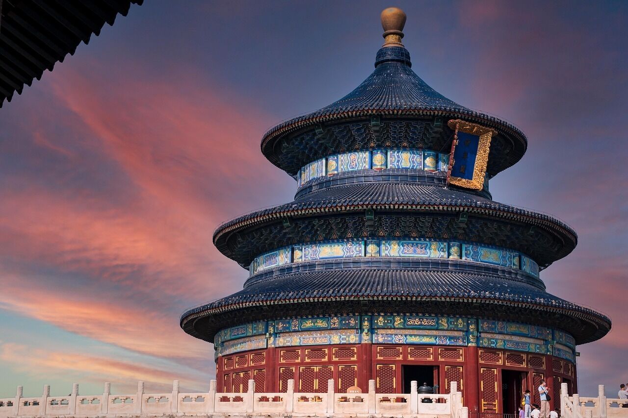 A traditional Chinese building with a multi-tiered roof and intricate blue and gold decorations.
