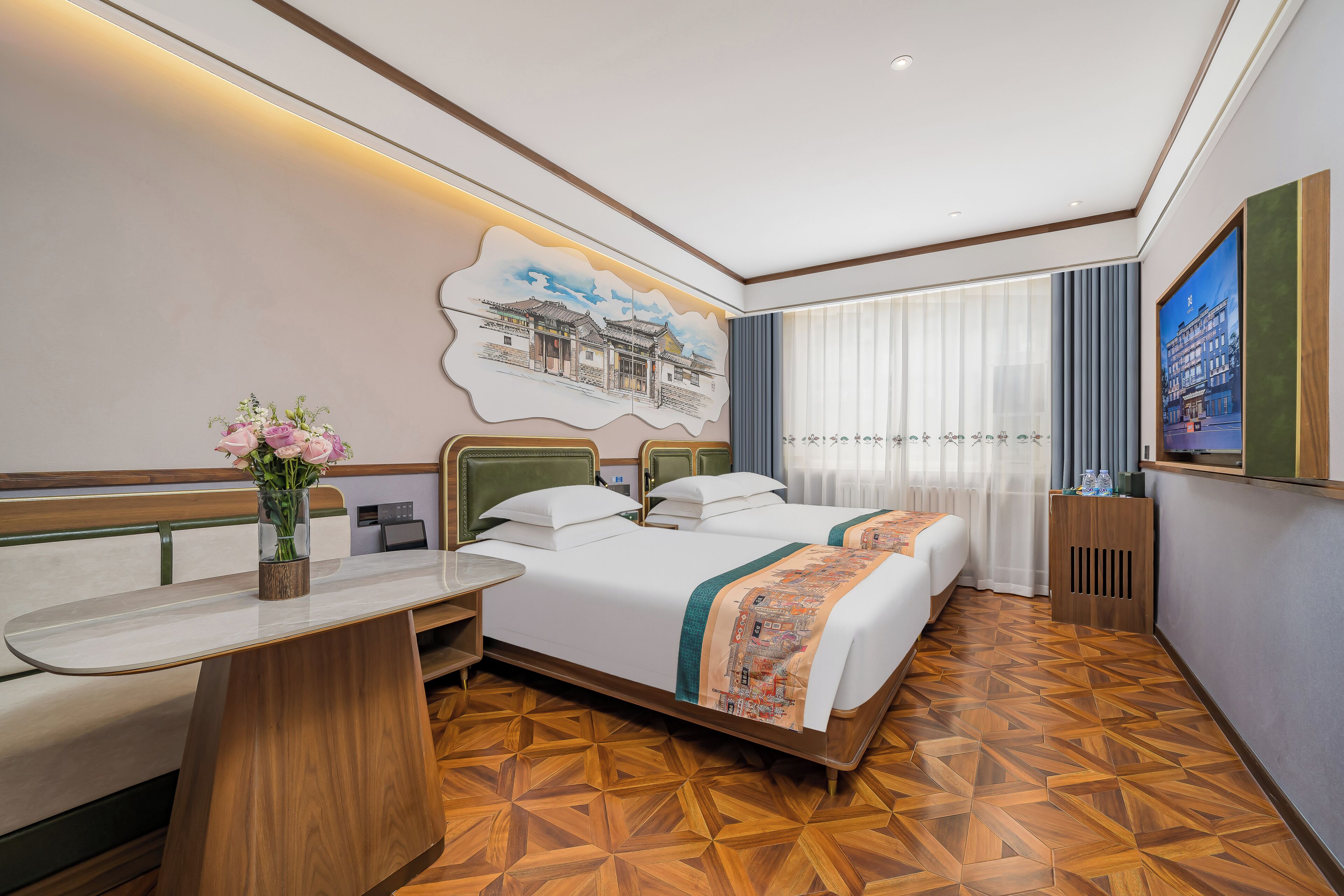 A hotel room with a bed, bedside table, and a large window with curtains.