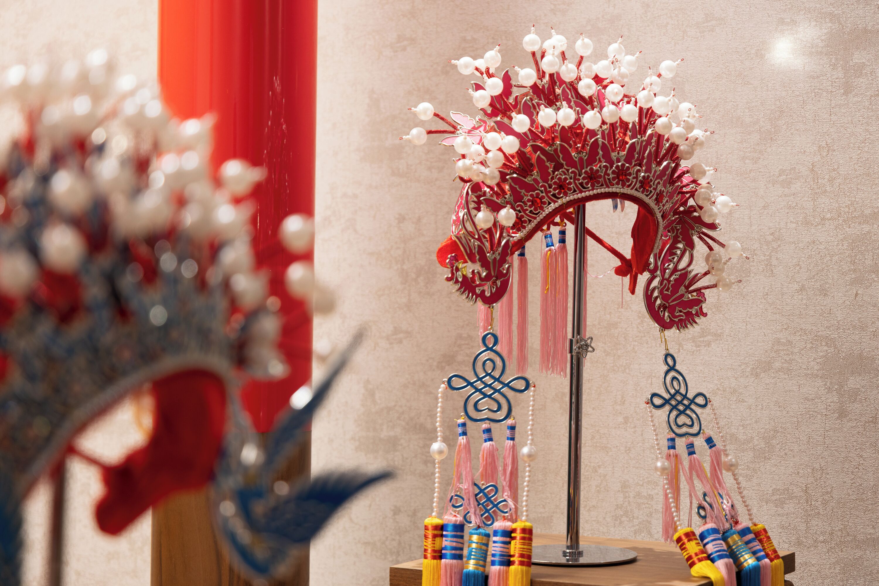A decorative item with a red and white color scheme, featuring a symmetrical design with hanging elements.