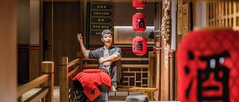 A traditional Chinese interior with wooden furniture, a red lantern, and a sign with Chinese characters.