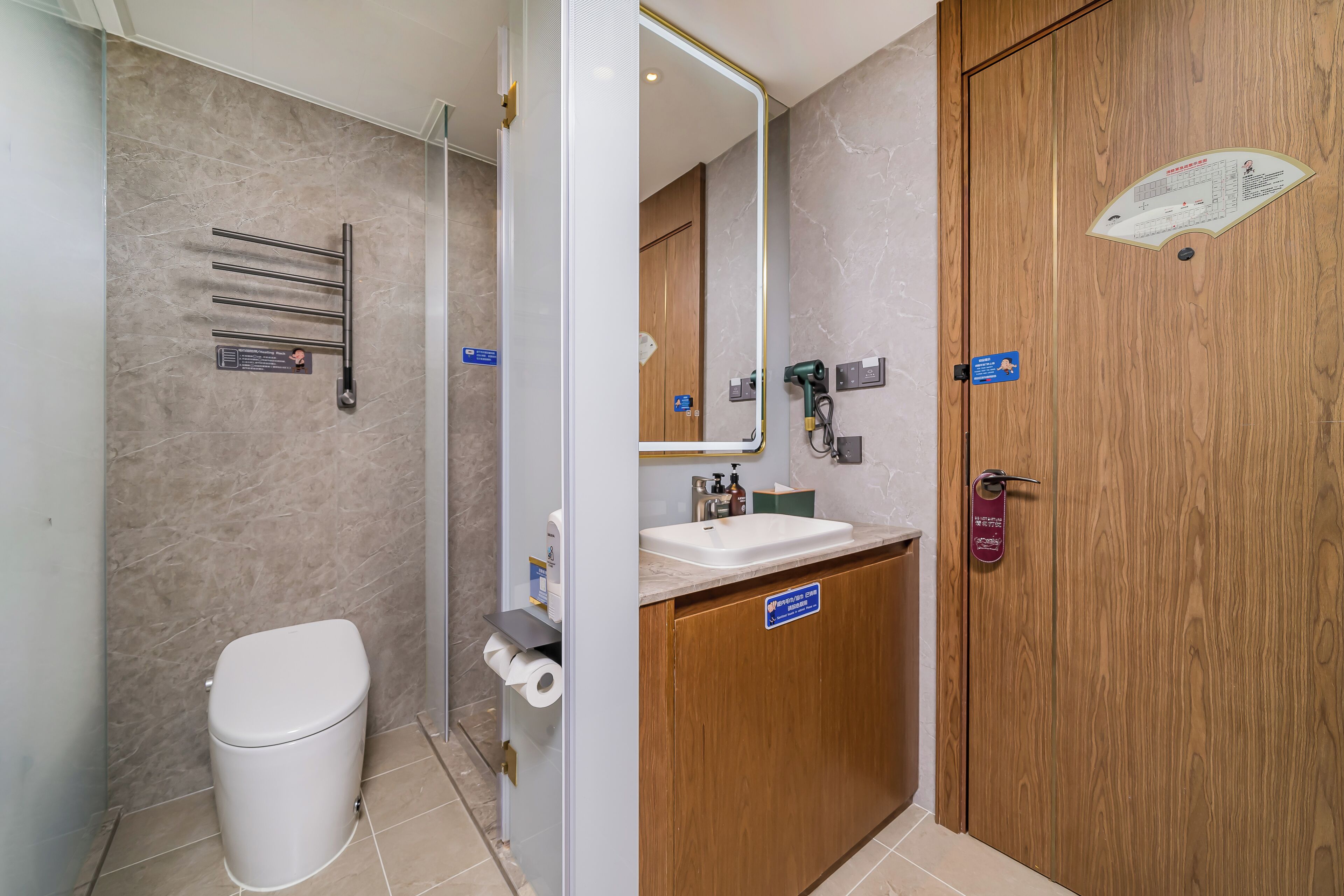 A bathroom with a toilet, sink, and towel rack.