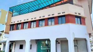 A two-story building with a flat roof and a glass extension. - Quee Hotel (George Town)